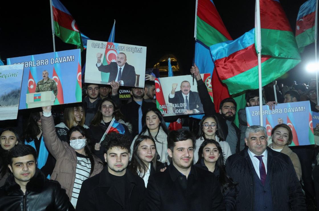 Supporters of Ilham Aliyev, Azerbaijan&#039;s incumbent President and a candidate for the Azerbaijani presidential elections, celebrate in a street following the announcement of exit poll results in Baku, Azerbaijan, Feb. 7, 2024. (Reuters Photo)